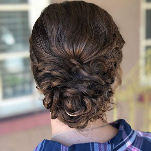 back view of a woman's low bun braided hairstyle