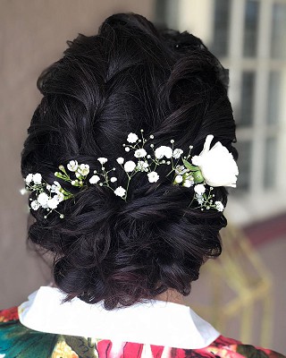 Back view of woman in bridal hairstyle with floral design